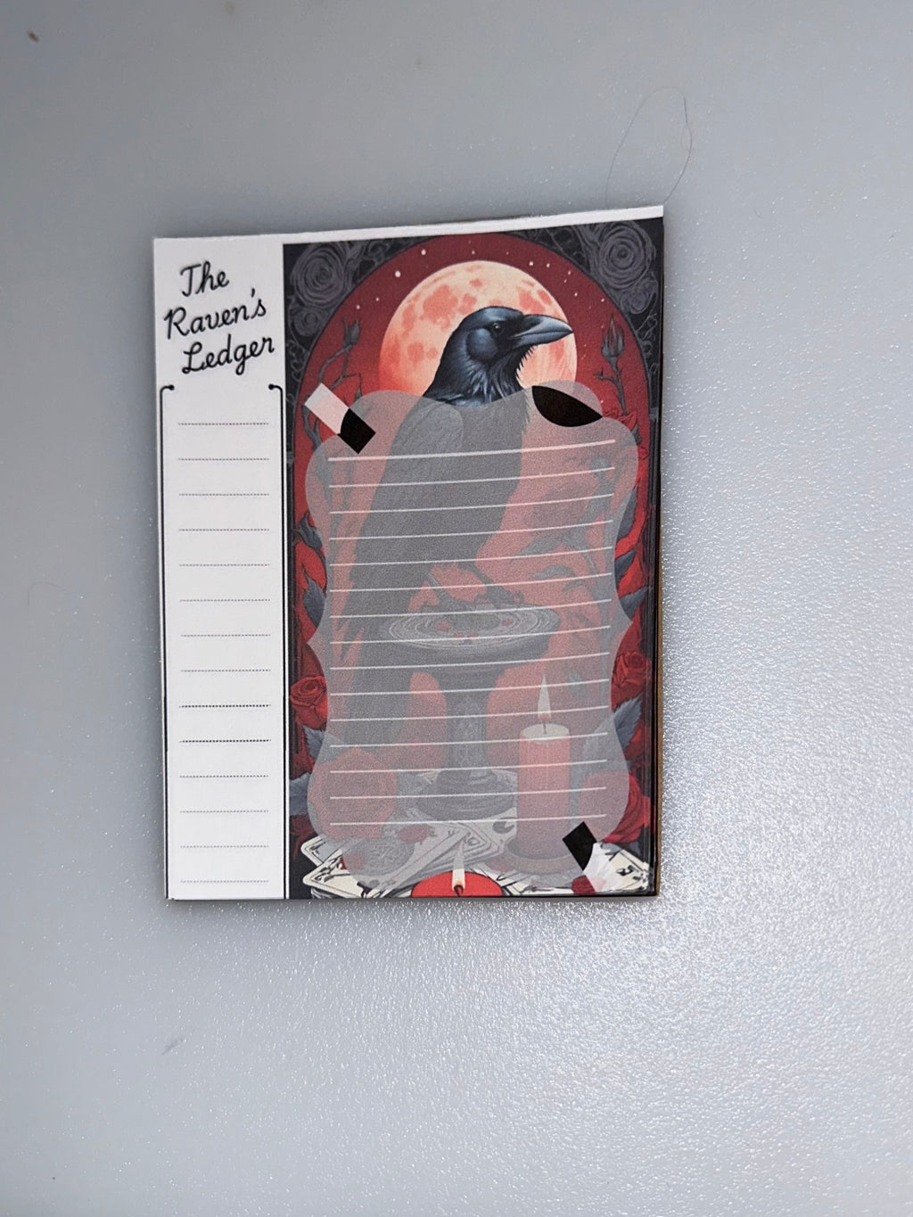 The “Ravens Ledger”notepad with full moon, tarot cards, candles, and gothic raven art