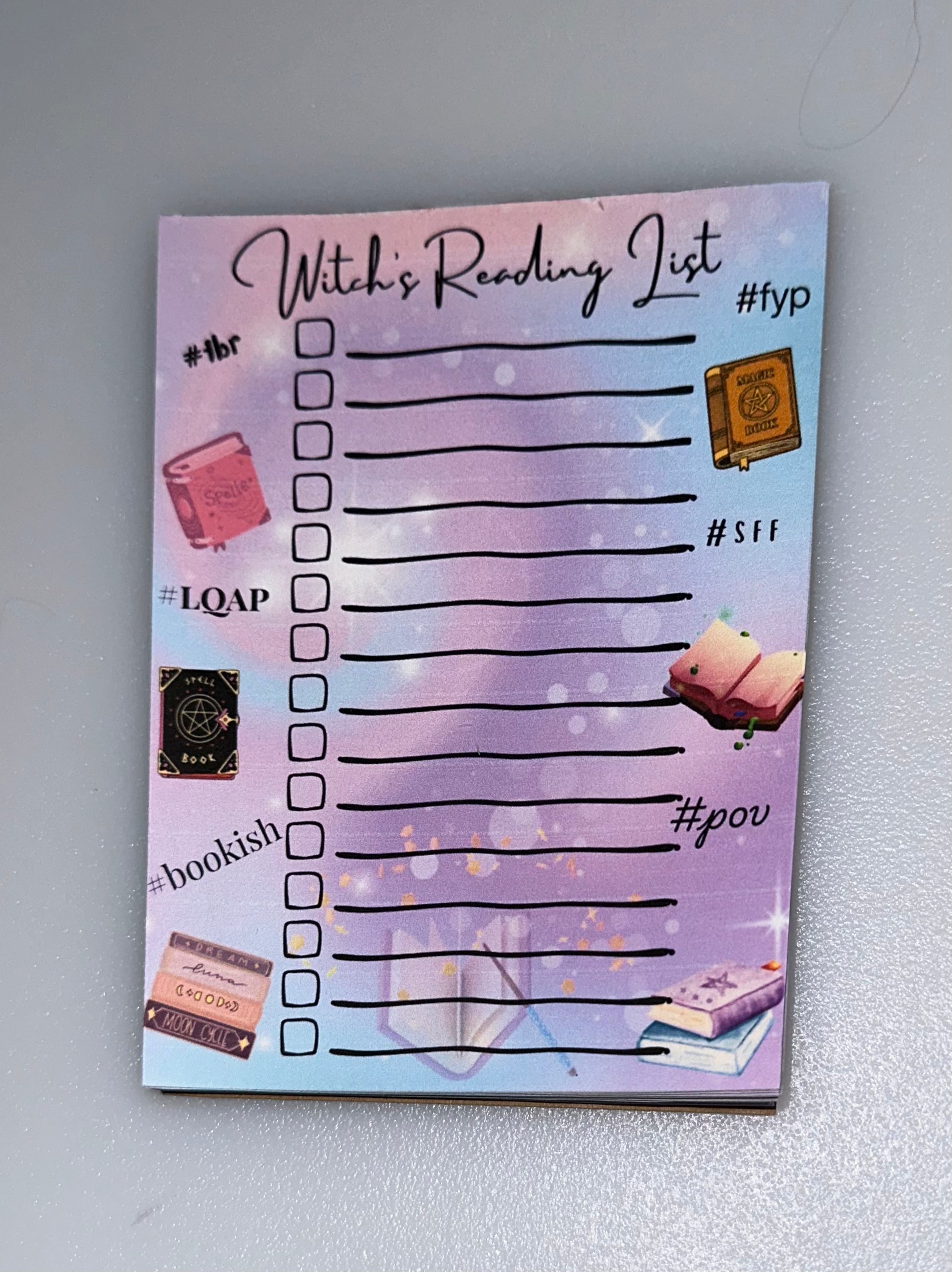 “Witch’s Reading List” notepad with bookish illustrations and hashtag labels