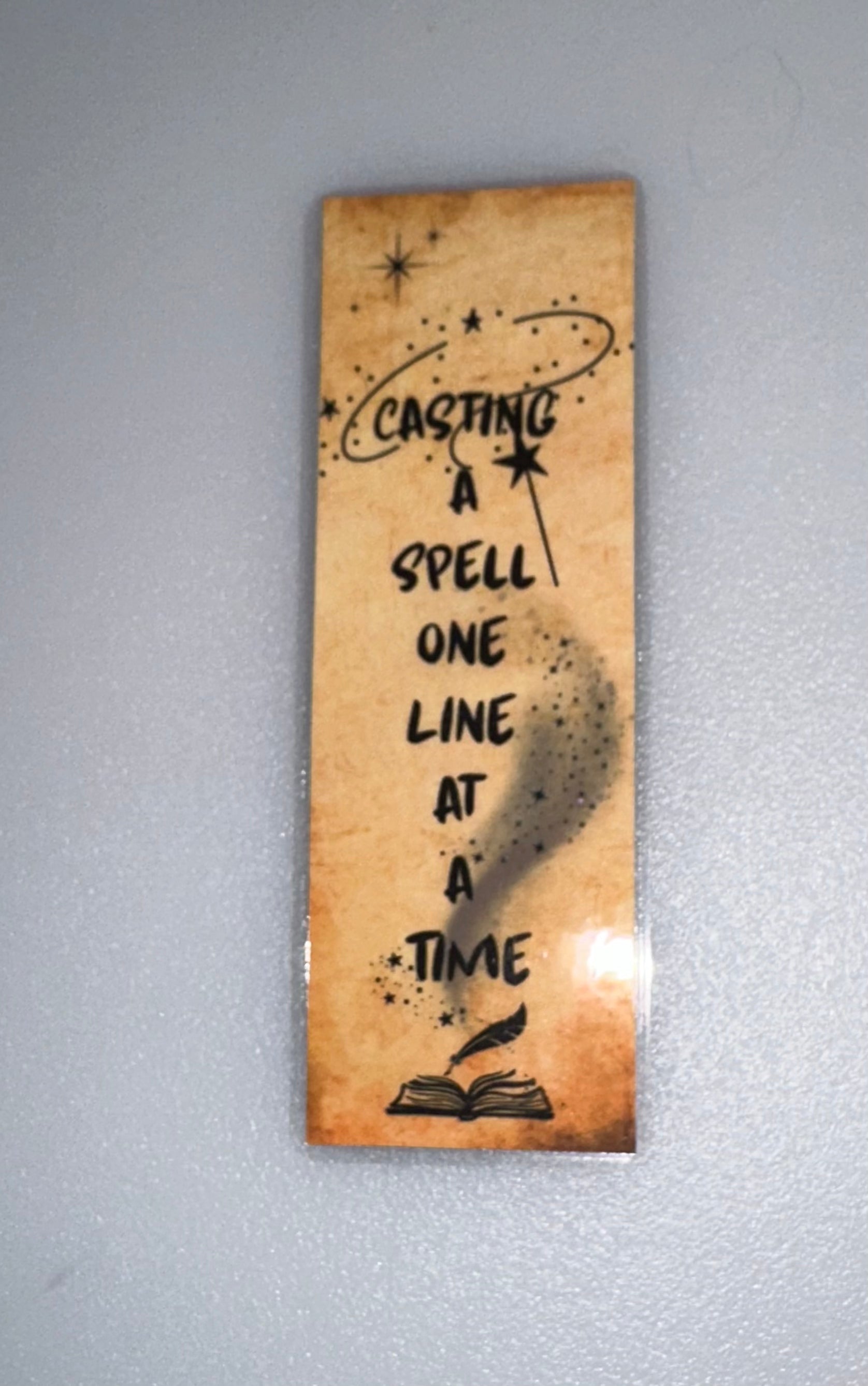Aged parchment printed bookmark with magical quote - “Casting a Spell One Line at a Time”